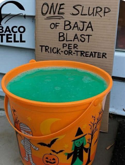 Halloween bucket filled with baja blast with sign one slurp per trick or treater