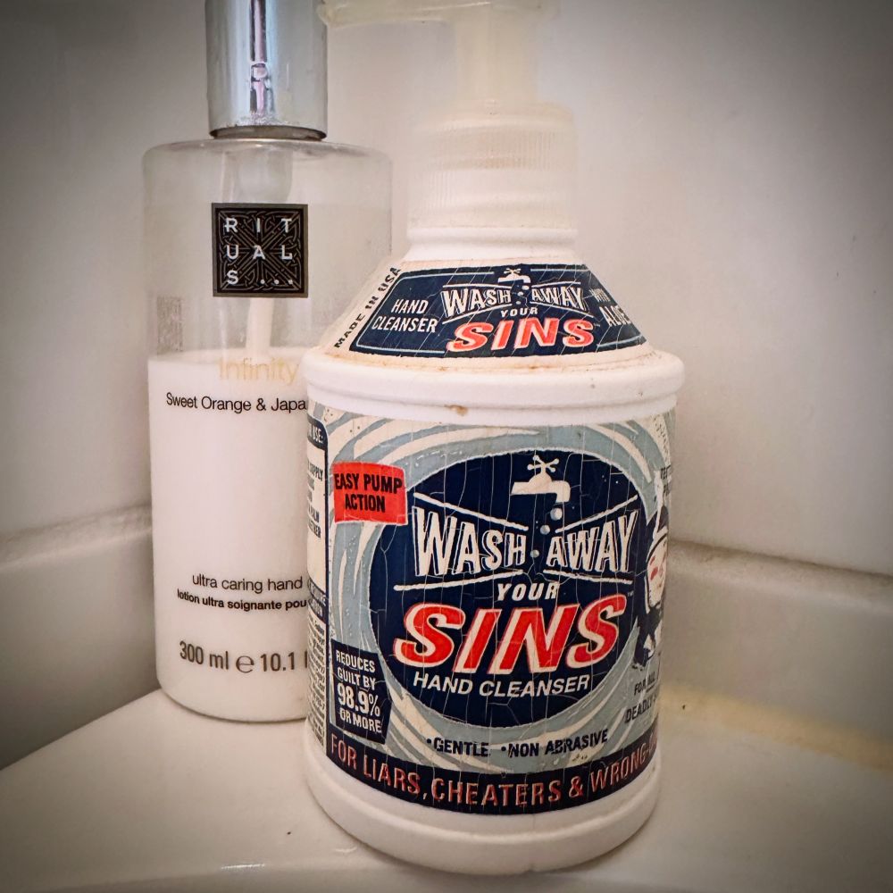 Hand soap container with an oldschool label: “Wash away your sings Hand Cleanser”