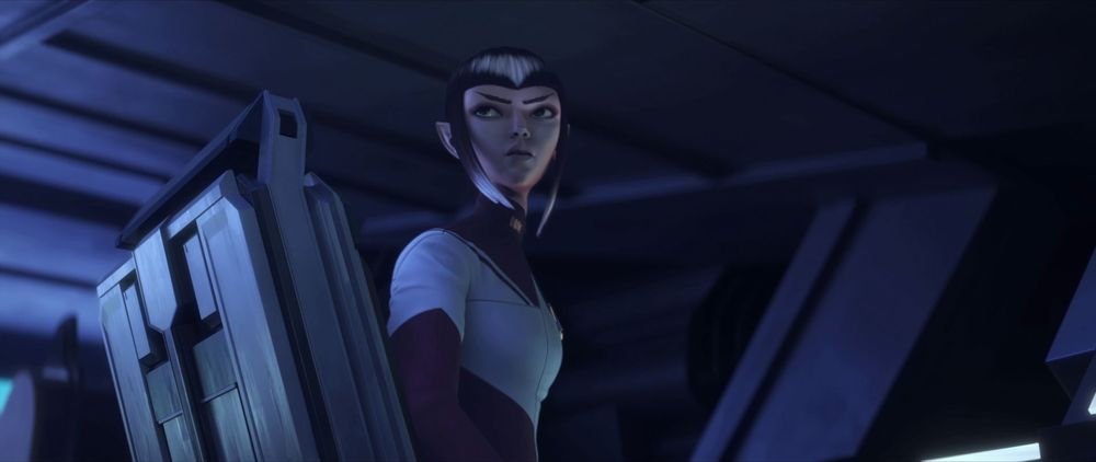 The Vulcan Maj'El sitting in a chair in, looking back at someone off camera.