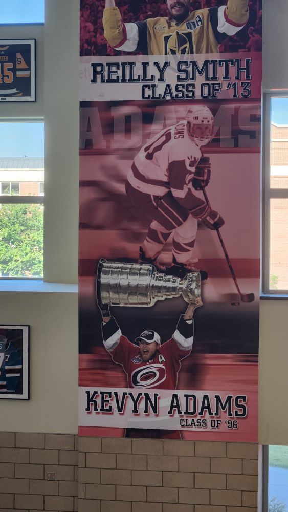 Giant image of former Hurricane Kevyn Adams raising Lord Stanley.