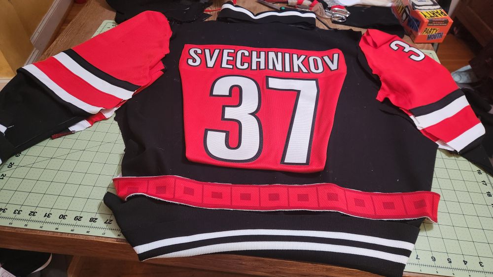 Back view of the varsity jacket in progress. Flag trim and jersey sleeves being reused. Svechnikov nameplate and number 37 haven't been fully but yet, but are positioned approximately where they go on center back.