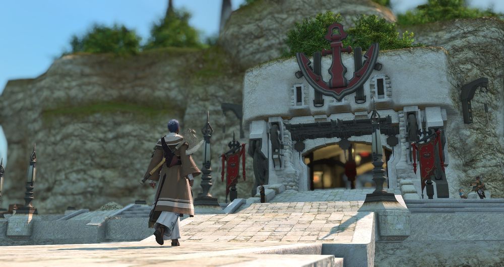 A screenshot from Final Fantasy XIV. A female Hellsguard Roegadyn is dressed in a brown cloak with an axe strapped to her back.  She walks towards an entrance, a large anchor above the archway. Red banners depicting the symbol for the city state of Limsa Lominsa hang nearby. 