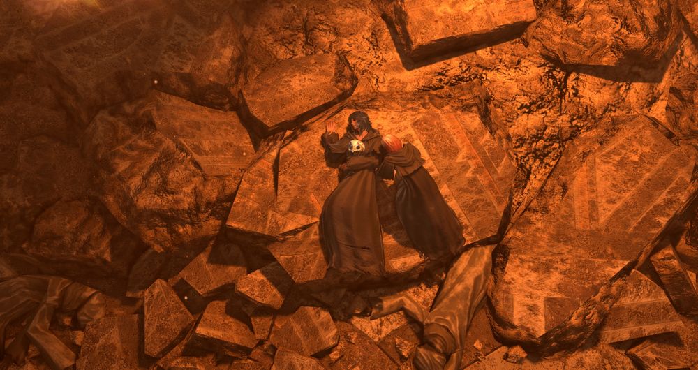 A screenshot from Final Fantasy XIV. A blue-haired woman in a dark robe lays on her back on some debris, flames burning around her. Another woman in a dark robe, with red and white hair, leans over her, looking to the first woman's face. 