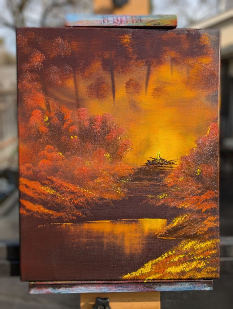 Oil painting based on the Bob Ross painting "Campfire". It shows a dark forest in oranges, reds, and browns with a bright campfire illuminating the scene.