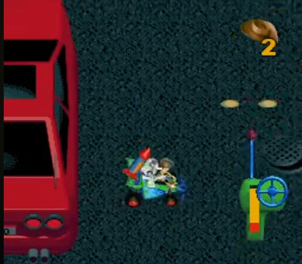 screen shot of the SNES version of Toy Story .

top down view of the level towards the end where buzz and woody ride around on the back of the rc car around a city street.