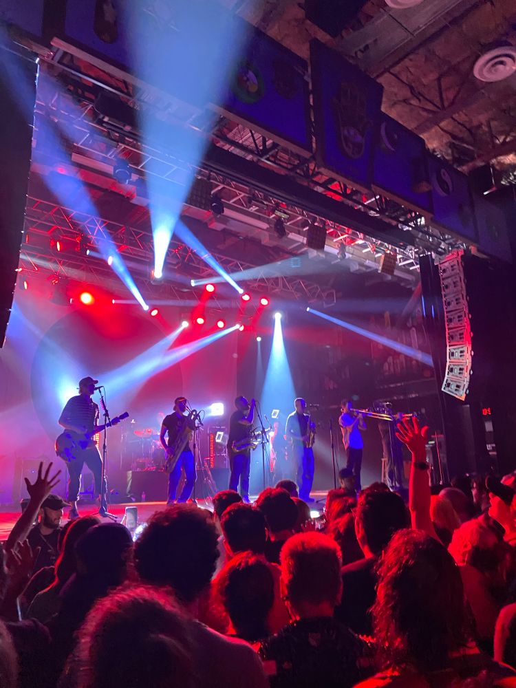 pic of Streetlight Manifesto on stage playin a banger. lighting is blue and red 