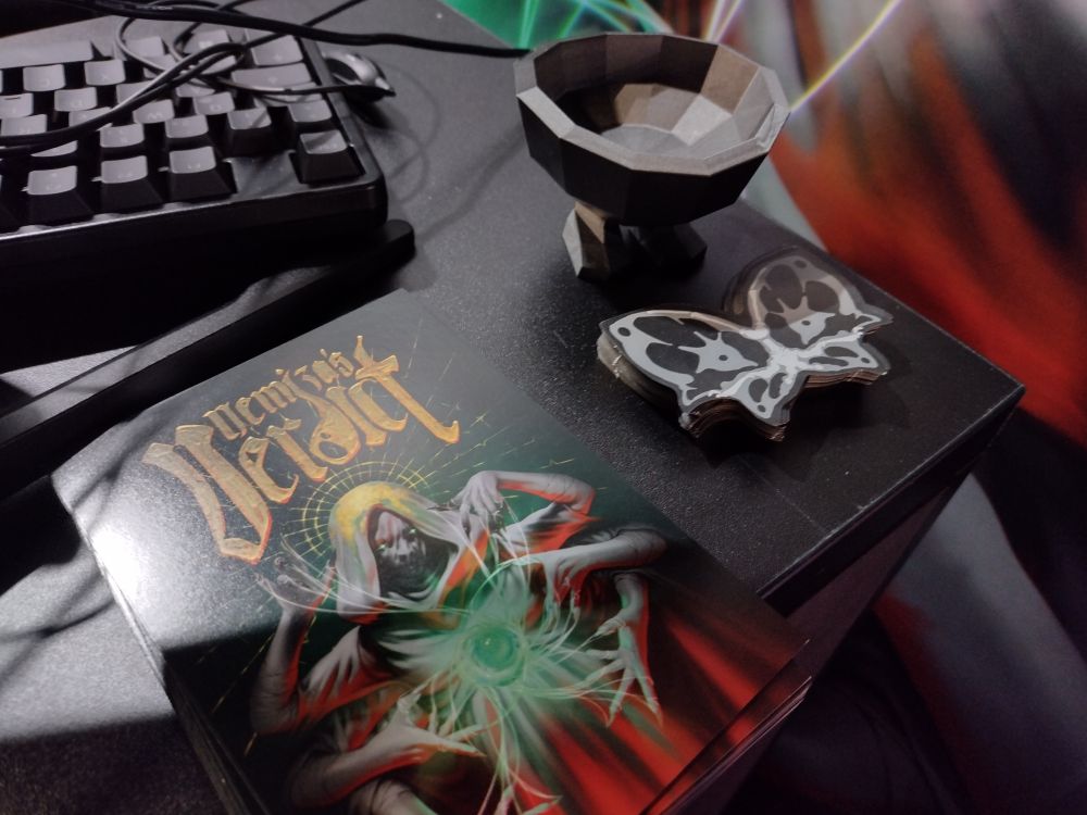 Nemizas Verdict Booth table with business cards, flyers and a little pot figurine