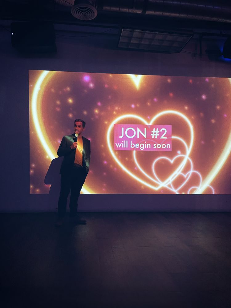 Lucas Eubank standing in front of a screen before his film screening
