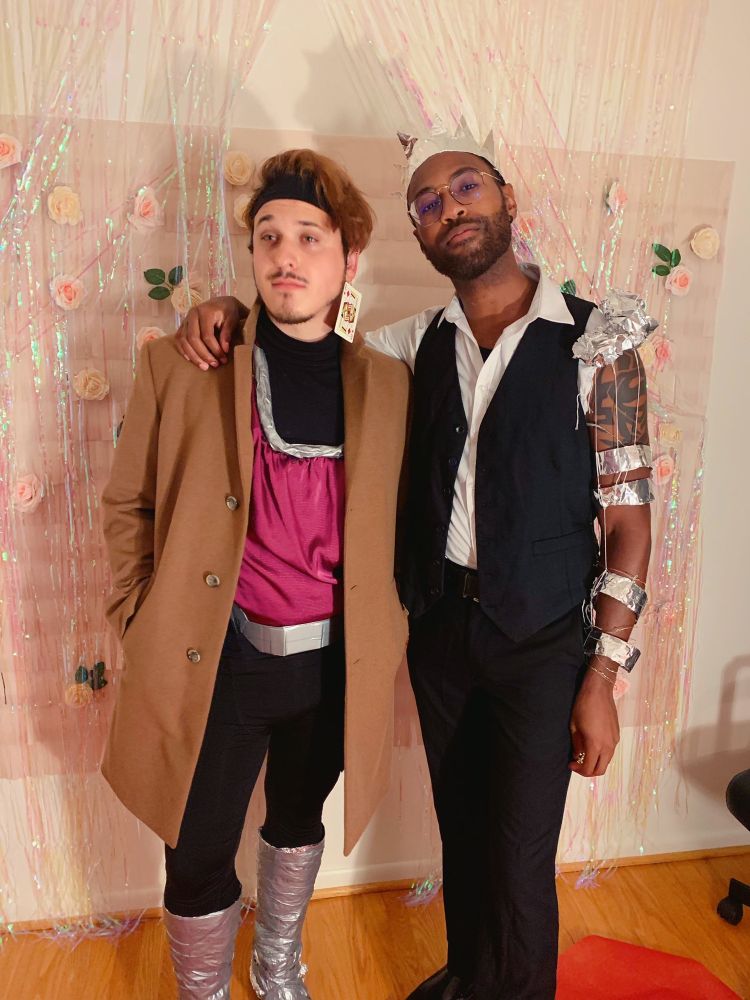 Picture of Prof on the left and Blizz on the right, standing together. Prof is dressed as Gambit from Marvel, and Blizz is dressed up in a suit with some lights and tin foil with a crown. 