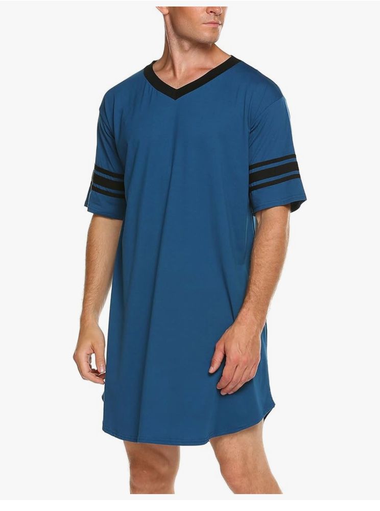 Picture of a clothing model wearing a blue shirt that goes down to the knees and has 3 black stripes on each arms with a v neck outlined in black. 