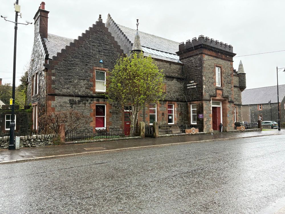 The outside of the Stewartry Museum. A grey stone building in the rain. 