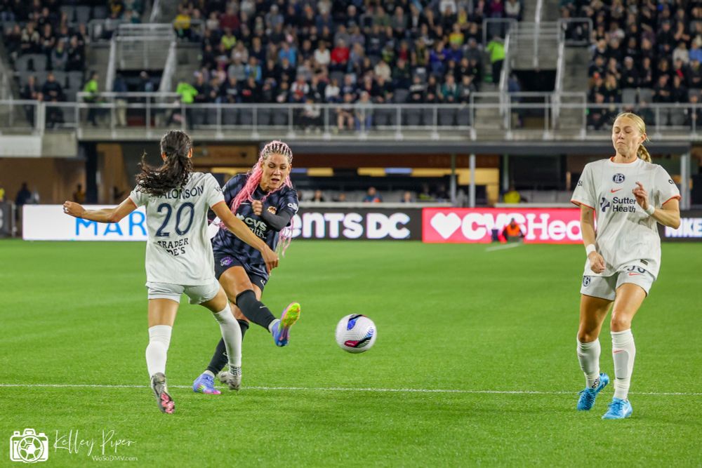 Spirit forward Trinity Rodman takes a shot on goal as Bay defender Alyssa Malonson moves out to attempt a block.