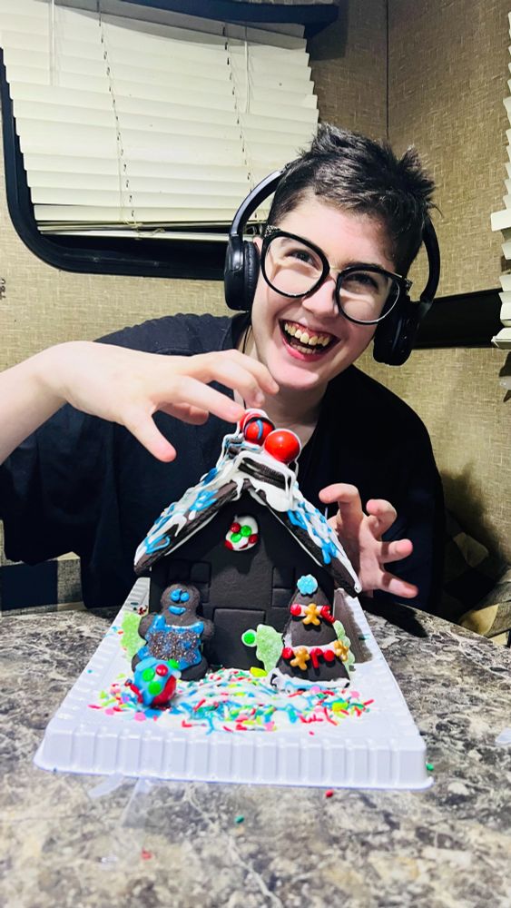 L is full of smiles as he pretends to claw at his Oreo gingerbread house. He definitely used the most of the decorations on the actual house - as opposed to eating them first! There is white and blue icing, red gumballs, oreo cookies, sprinkles, and a decorated tree and gingerbread man.