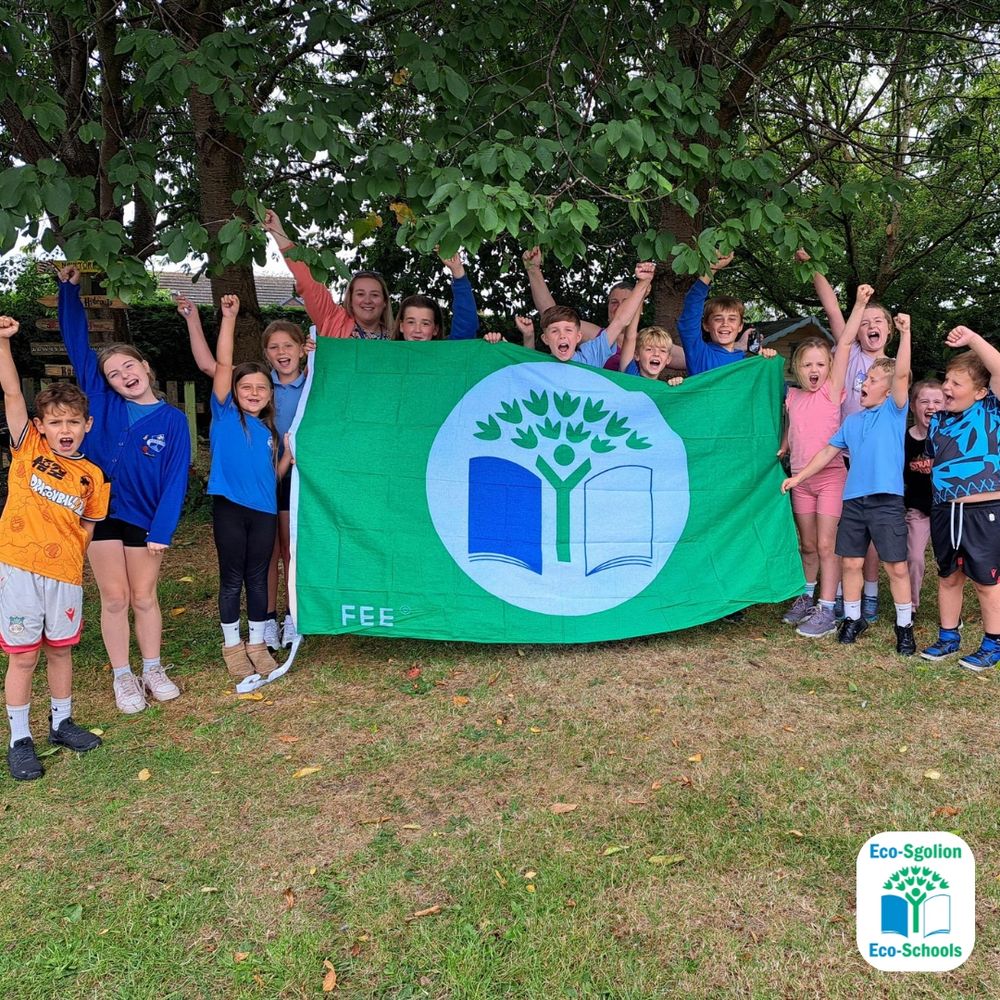 Young learners holding up their Green Flag