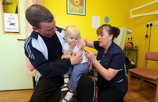 A child is vaccinated for measles