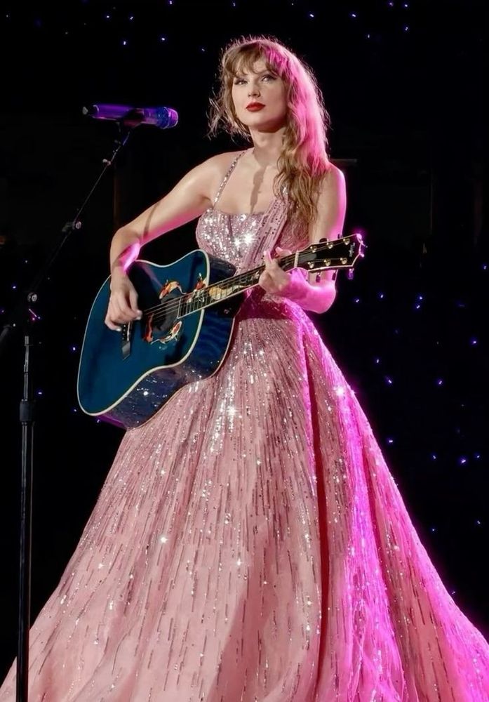 pink sparkly speak now gown holding koi fish guitar photo from pinterest