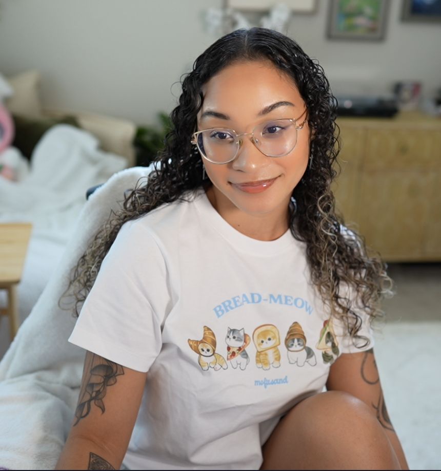 woman with curly hair taking a selfie wearing a Mofusand shirt 