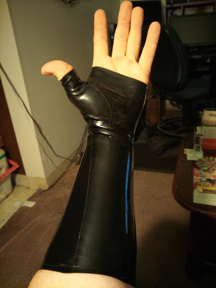 Photo showing my left arm wearing a latex fingerless glove, palm towards the camera 
