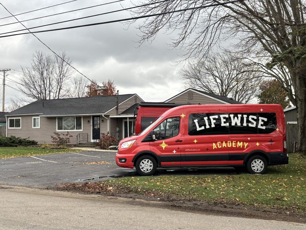 LifeWise Academy truck parked outside house.