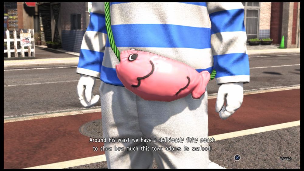 Screenshot from Yakuza 6.

"Around his waist we have a deliciously fishy pouch to show how much this town adores its seafood!"