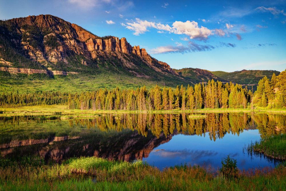 Pond and mountain at sunrise. Shoshone National Forest, Wyoming