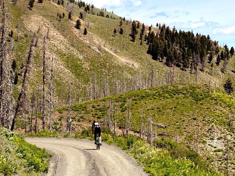 Cyclist on dirt road in mountains 