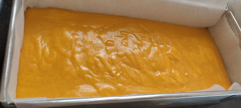 the orange colored batter in a rectangular tin