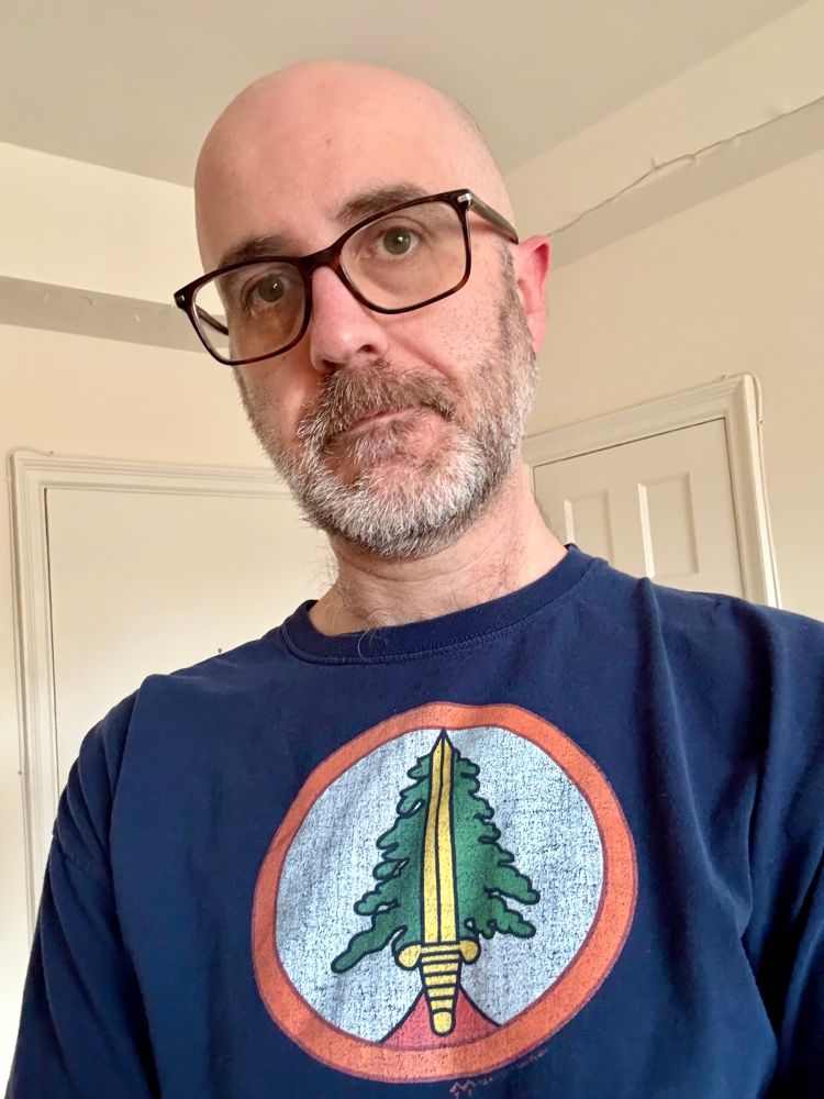 Selfie of an awkward dude wearing a Bookhouse Boys t-shirt.