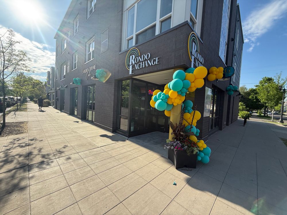 Storefront with green and yellow balloons and a sign that says Rondo Exchange