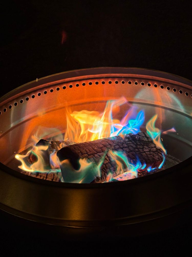 Multi-colored flames in a fire pit 