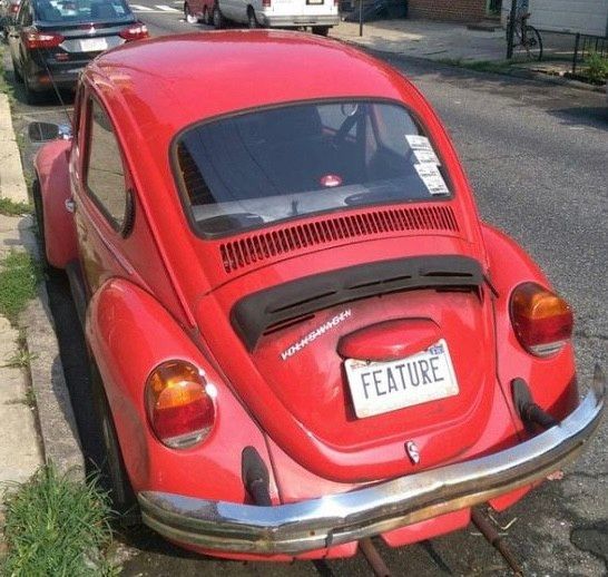 "It's a feature, not a Bug."

VW Beetle with "FEATURE" license plate.