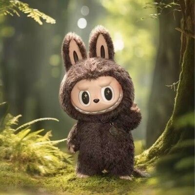A brown labubu doll in a forest setting