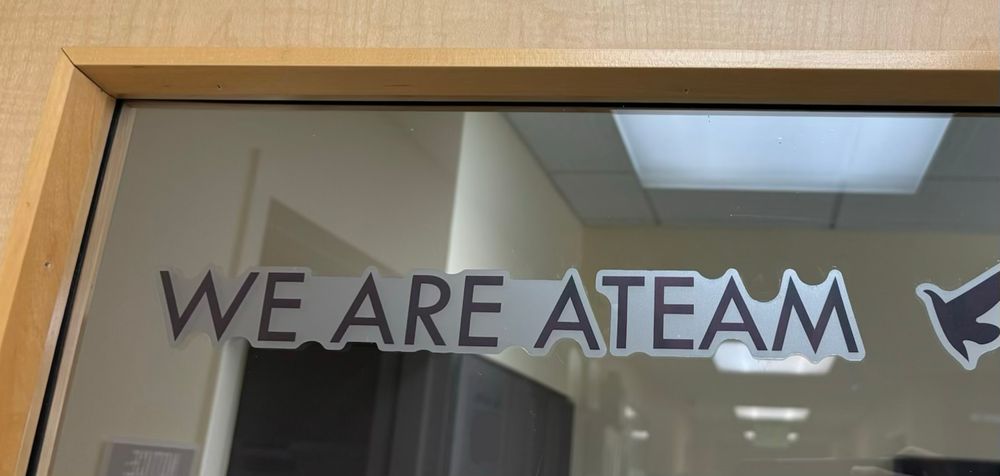 Photo of a motivational sticker on a window, says “we are a team”. 

I get the final fifteen speech stuck in my head every time I see this.
