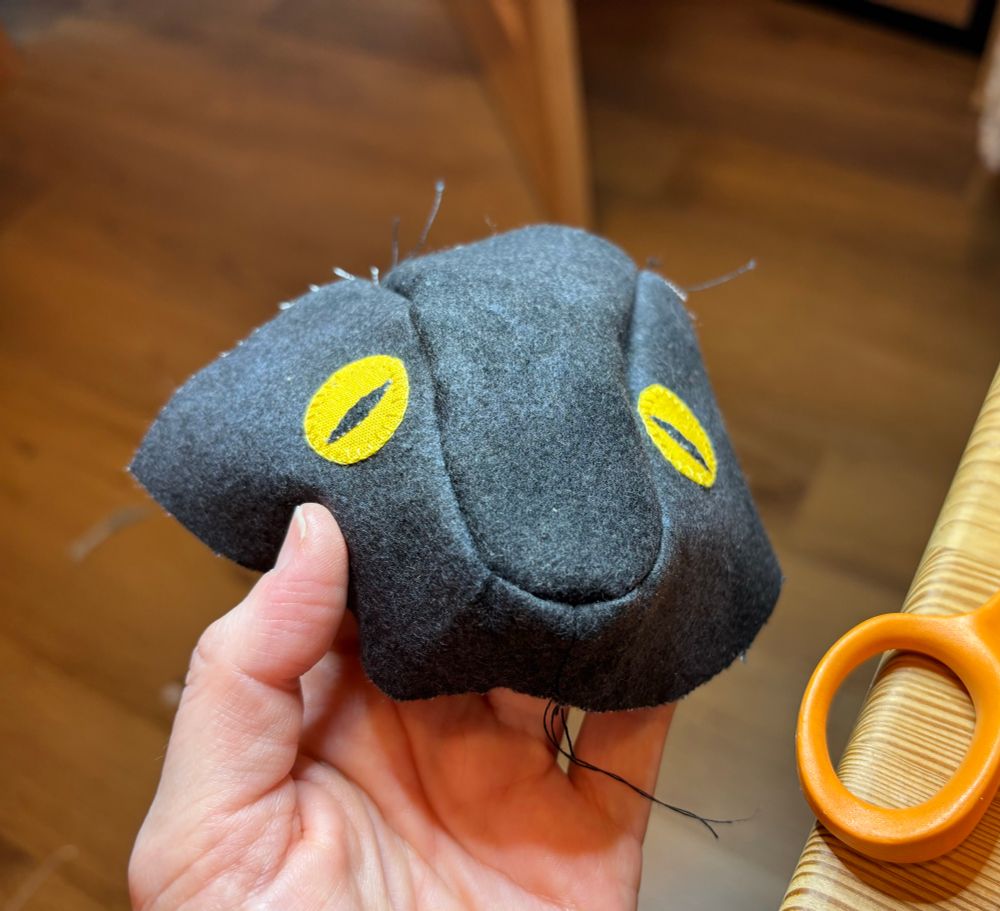 half of a snake head, made out of fabric