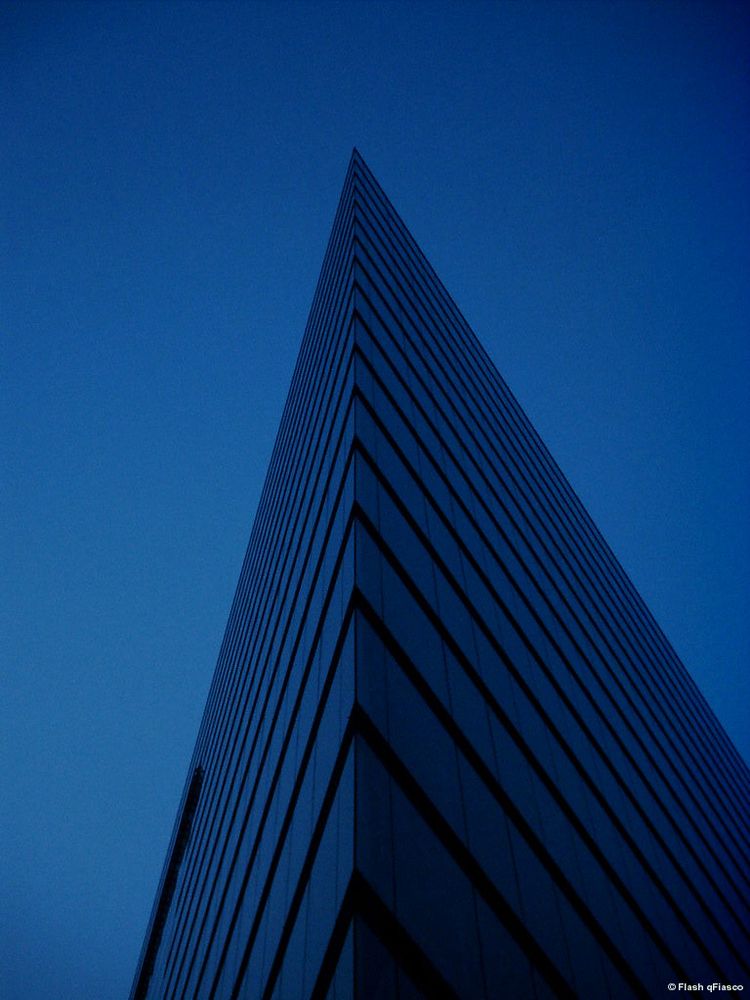 Pyramidal shaped skyscraper against a cloudless deep blue sky, Düsseldorf, Germany.