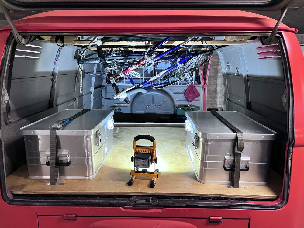 Two bicycles in the cargo bay of classic VW van.