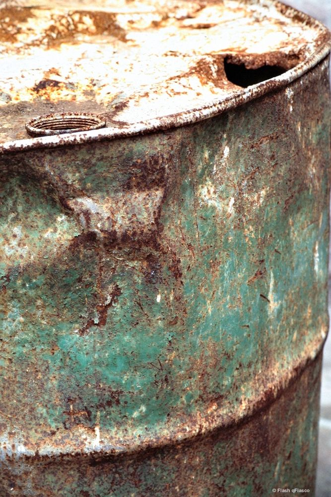 closeup image of rusty oil drum, showing colors and textures. copyright Flash qFiasco