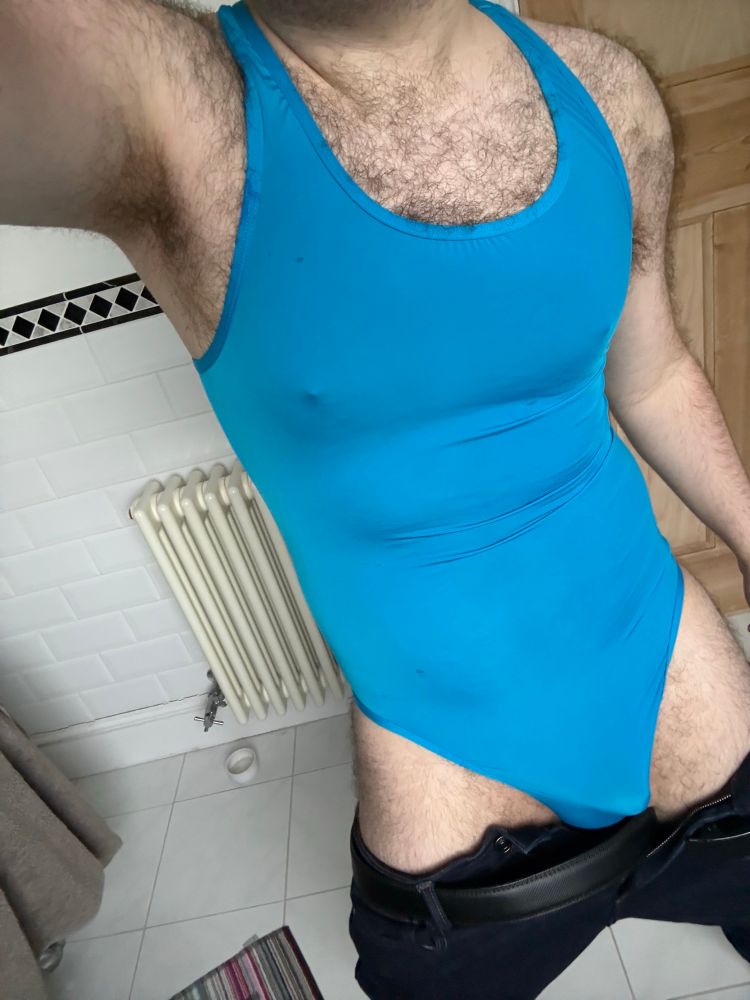 Bathroom shot in a Lycra blue bodysuit. 