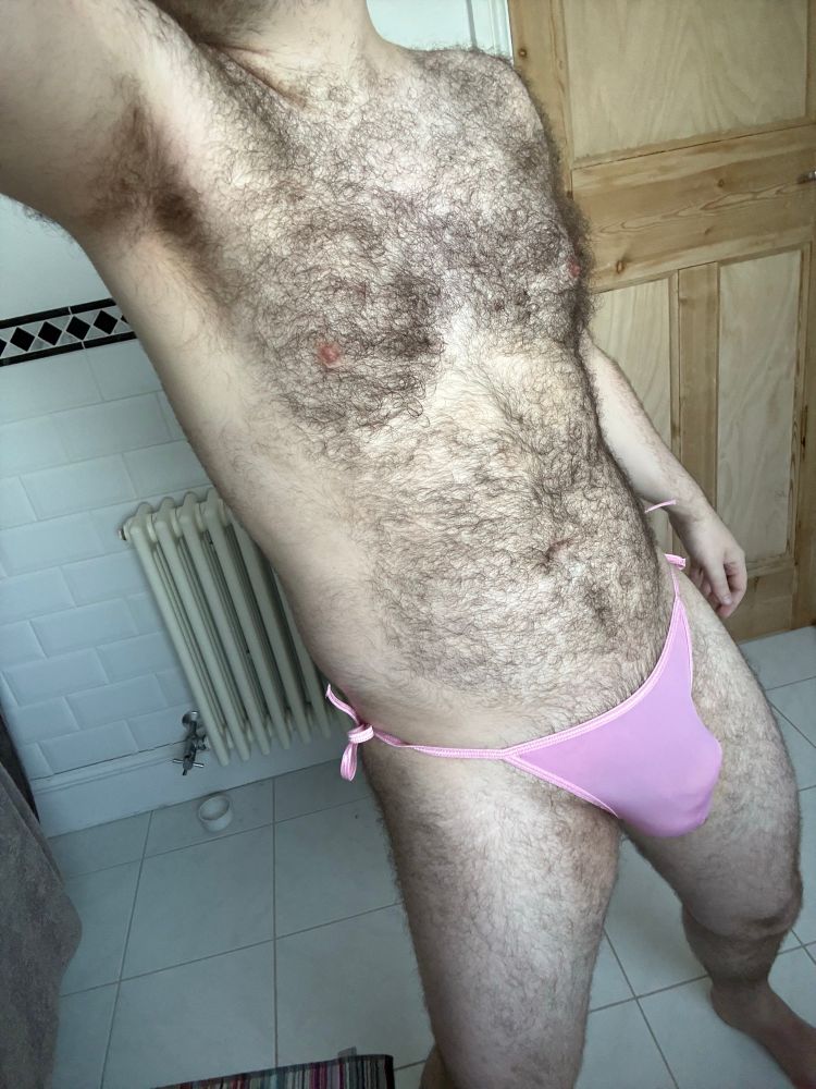 Front body shot in side tie pink thong. 