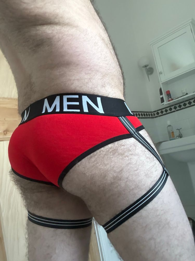 Butt in red briefs with attached garters 