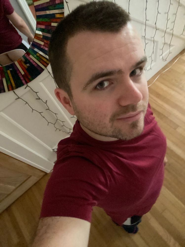 Standing in hallway showing off new hair cut. Mirror shows butt. 