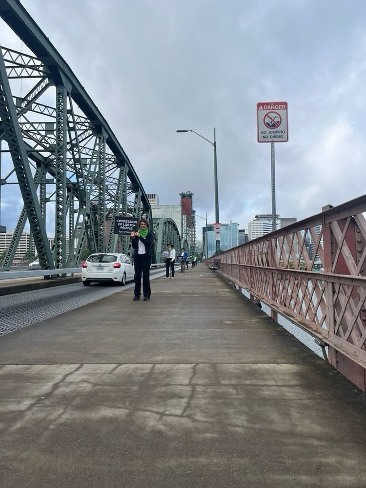 Woan on Hawthorn Bridge, Portland, OR
Holding Sign: Oppression of LGBTQ+ People 