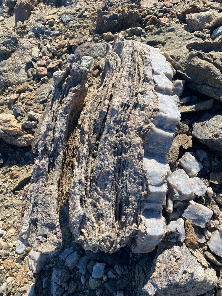 Layers of rock and crystal that formed due to pressure and heat; Bunger Hills Antarctica 