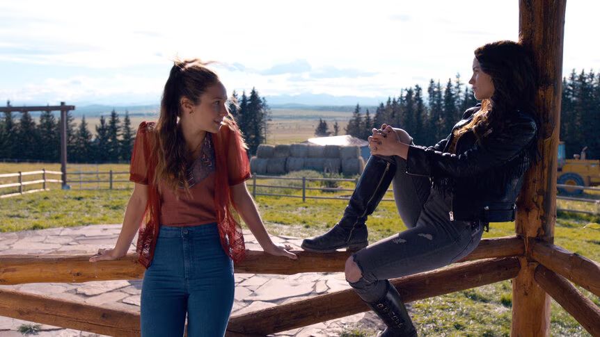 Wynonna and Waverly Earp sitting on their front porch