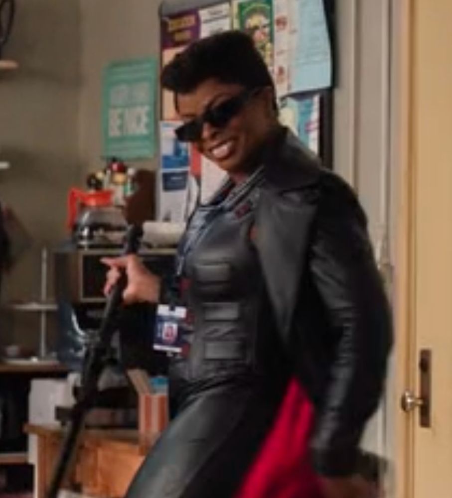 a medium shot of Abbott Elementary's Ava in her Blade costume swooshing her leather jacket around