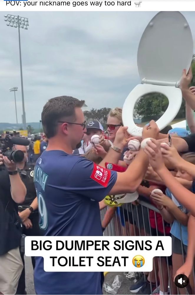Cal Raleigh signing a toilet seat