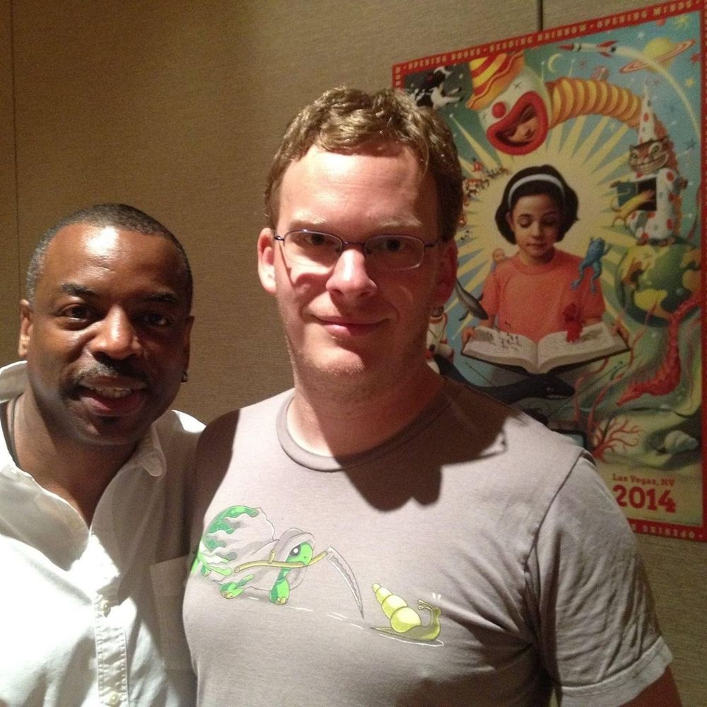 Picture of me with LeVar Burton in front of poster for 2014 re-luanch of Reading Rainbow.