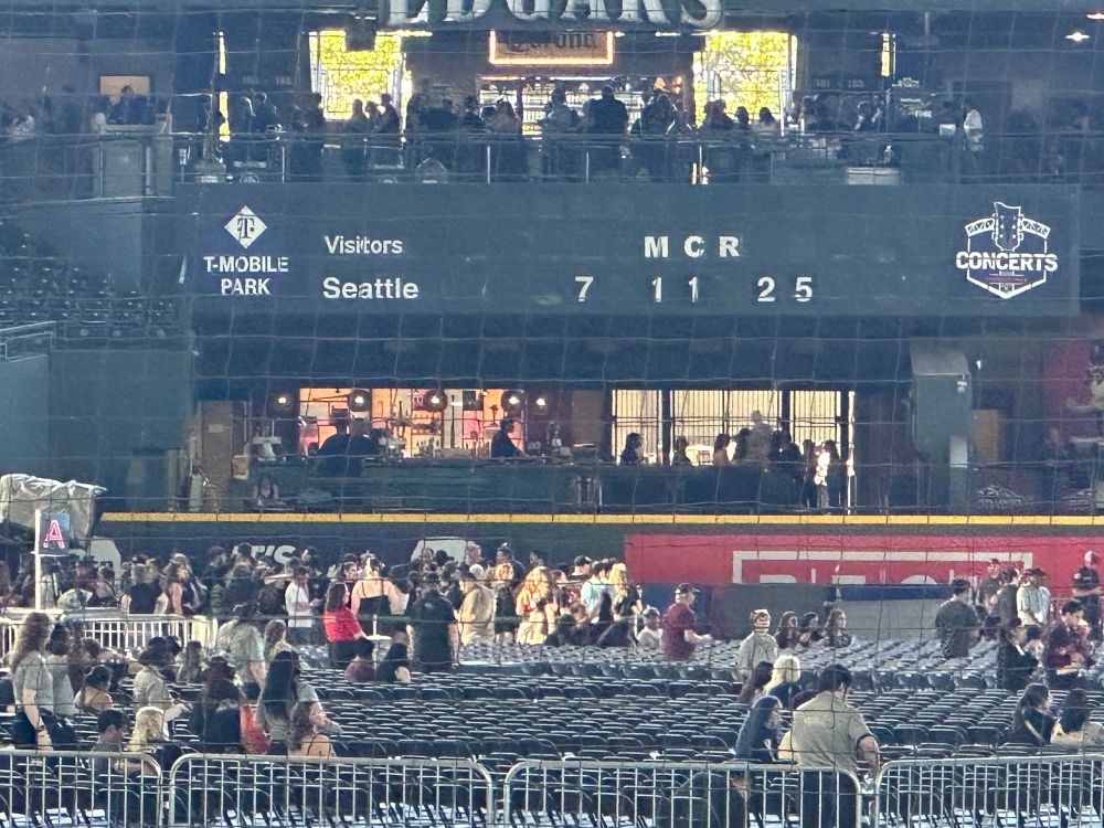 A picture inside T-Mobile park. The score board says “MCR 7 11 25.”