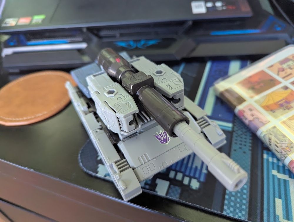 Transforming action figure in tank mode. Kinda just a wedge of plastic with a cannon on it.