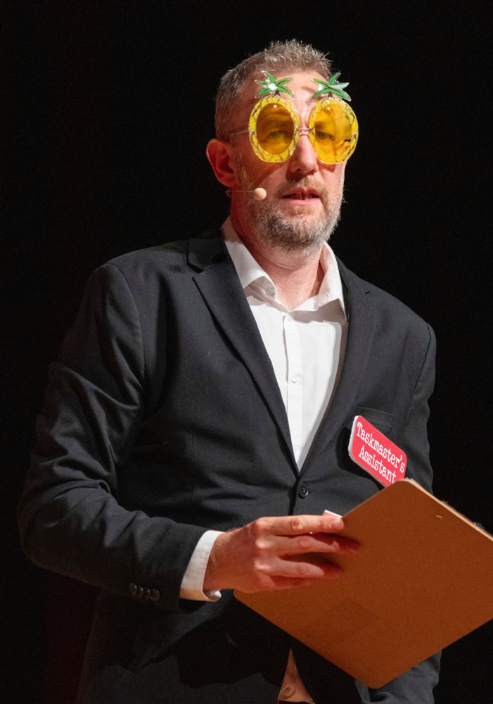 Alex Horne wearing pineapple sunglasses.